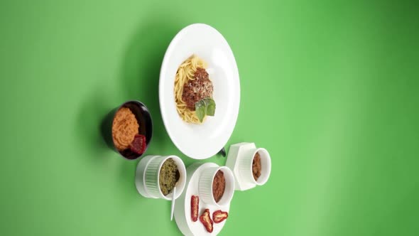 Vertical video: Pasta with pesto sauce in a plate alt