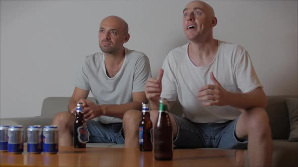 Fan Human Emotions and People Concept - Cheerful Young People Watching Sports on TV and Supporting alt