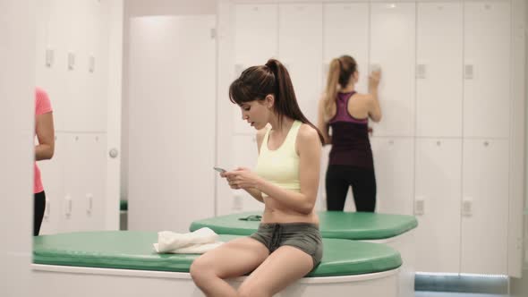 Young women relaxing in changing room after work out