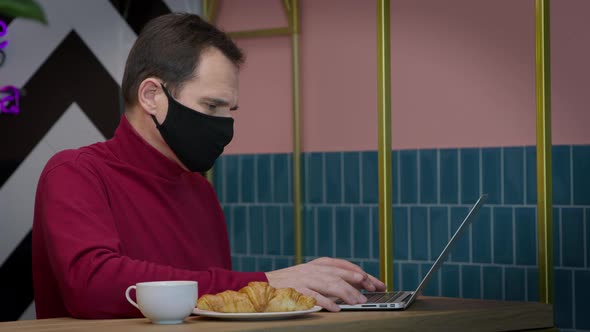 Businessman Quickly Typing Contract on Laptop Keyboard Working Remotely in Cafe