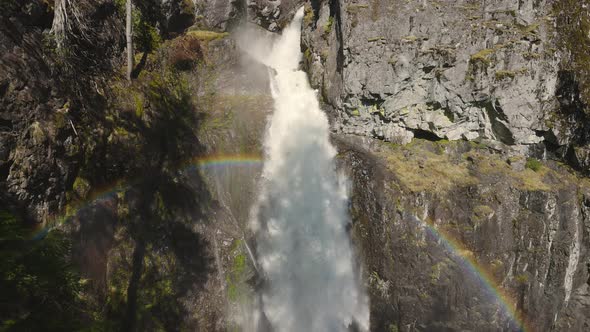 Waterfall Rushing Down a Rocky Canyon in the Canadian Mountains alt