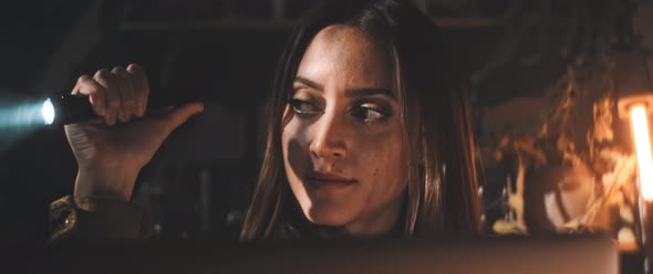 Woman uses flashlight in office alt