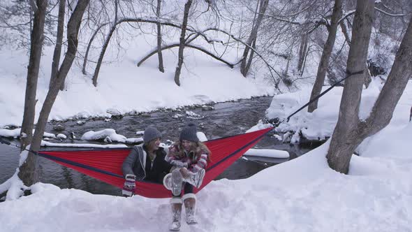 Sisters fighting in hammock as they try to put feet on another alt