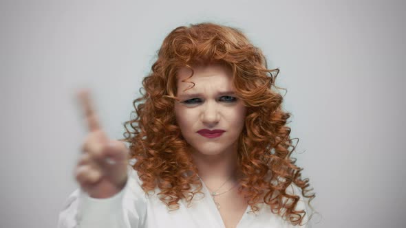 Stressed Woman Waving Hand No in Studio. Girl Crossing Hands on Grey Background alt