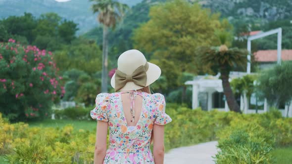 Elegant Hat with Ribbon Bow on Woman's Head During Summer Walk