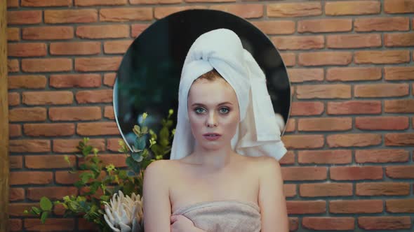 Portrait of Passionate Naked Woman Wore Into Towel Posing at Camera alt
