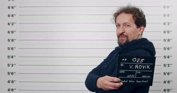 Side Profile Mugshot of Male Person in 40s Turning Head and Looking to Camera alt