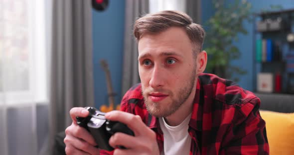 Happy Young Man Playing and Winning Online Game on Computer alt