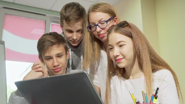 Low Angle Cropped Shot of Group of Teens Studying Together, Using Laptop alt