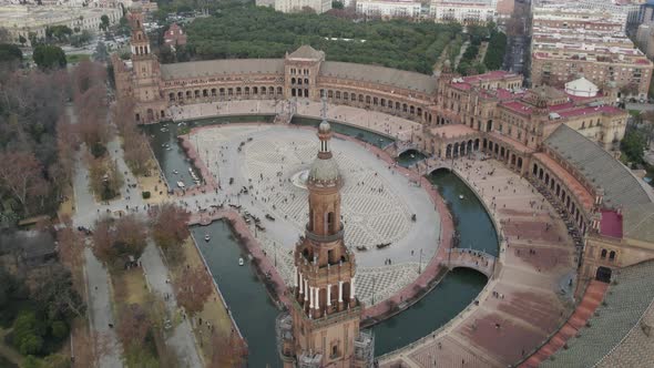 People at Spain Square or Plaza de Espana in Maria Luisa Park, Seville in Spain. Aerial forward