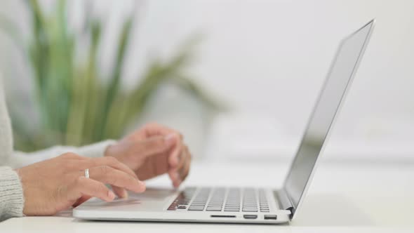 Close Up of Hands of African Woman Typing on Laptop alt