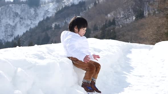Cute Asian Child Playing Snow Outdoors Slow Motion alt