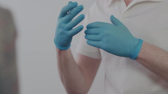 Dentist's hands in medical gloves close up. 
