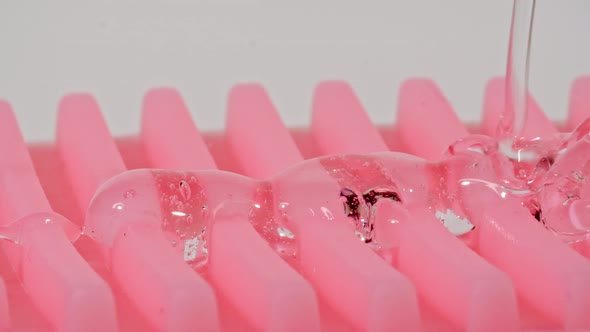 Transparent Cosmetic Gel Fluid With Molecule Bubbles Flowing On a Massage Brush alt
