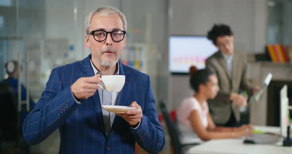 Thoughtful Handsome Caucasian Businessman Drinking Coffee alt