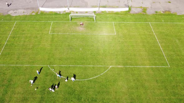 Training Of A Professional Football Team At The Stadium. Footballers Train Shots On Goal.