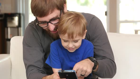 Father and Son using smart phone together