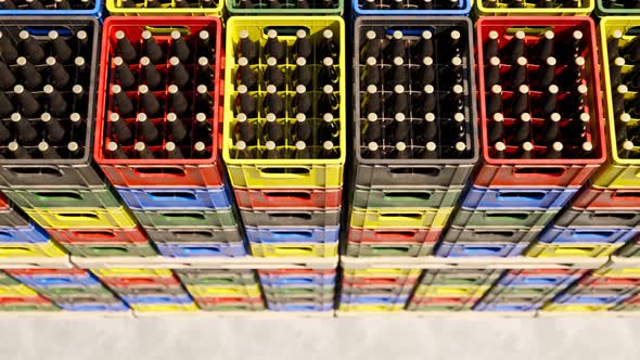 Loop of countless colorful beer crates stacked in an outdoor warehouse. 4KHD alt