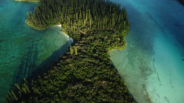 The small Ile Mwareya is part of the Isle of Pines in New Caledonia - aerial flyover alt