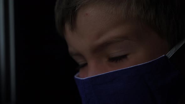 Little Passenger Wearing Facemask Looking at Train Window. Child-boy Looks at Sun. Six Years Old Boy alt