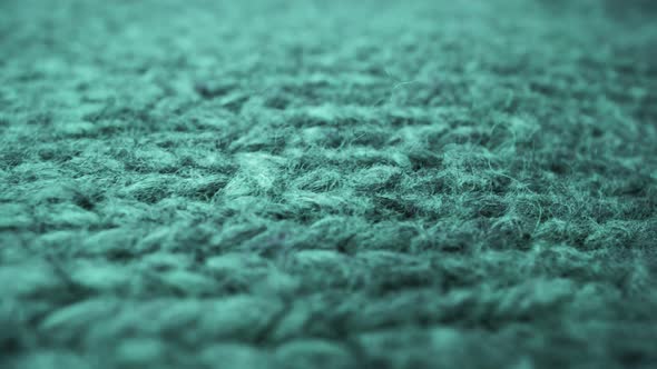 Extreme detail view of sheep wool cloth texture flowing in macro dolly shot. alt