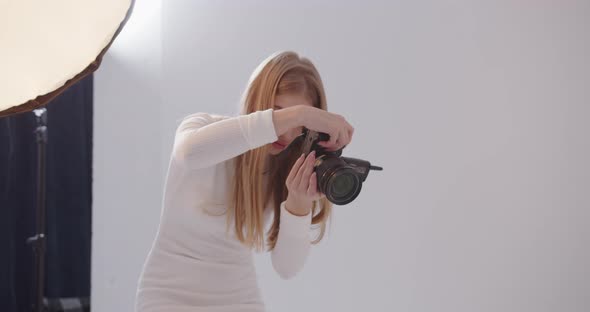 Girl Photographer Takes Pictures In The Studio