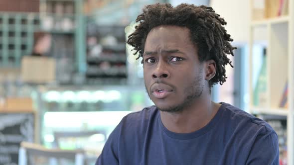 Portrait of Surprised African Man Feeling Shocked  alt