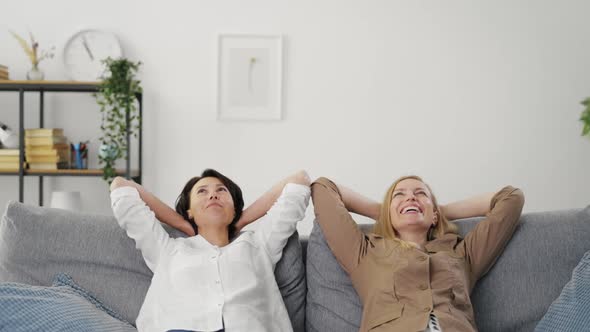 Two Women Relaxing on Couch
