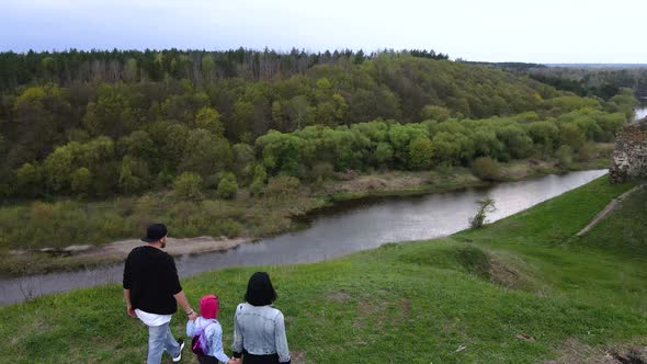 Happy family enjoys the view on the coast Sluch river hills, Gubkiv village