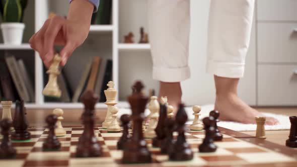 A Young White Asian Girl Makes A Move With A Chess Piece. Chess Game Player Girl Makes A Move alt