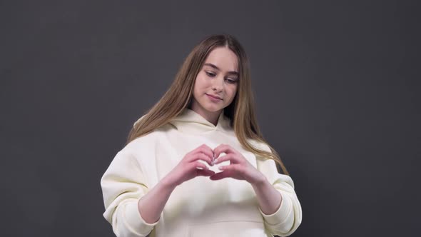 fold your fingers in the shape of a heart. express emotions and feelings of love alt