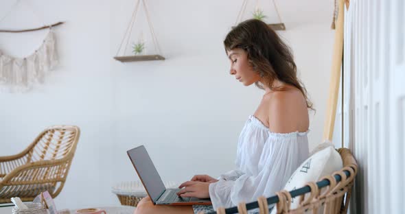 Bright Color Cafe Woman Typing the Massage on Keyboard of the Computer She Working Outsource alt