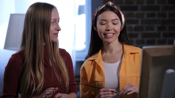 Joyful Female Friends Talking About New Canvas alt