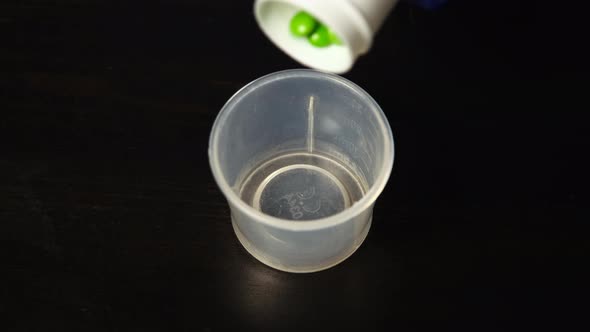 Hand Pouring Pills Out From Prescription Bottle alt