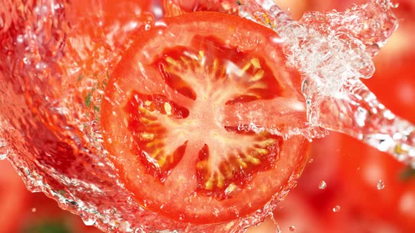 Super Slow Motion Shot of Splashing Water on Rotating Tomato Slice at 1000Fps alt