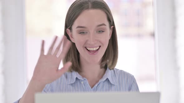 Portrait of Cheerful Young Woman Doing Video Chat on Laptop alt