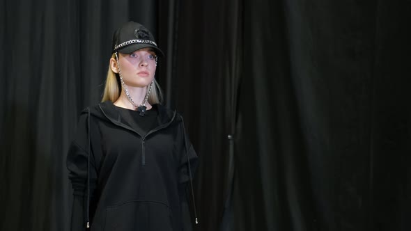Girl in Designer Cap with Chains Walks on Catwalk Runway Podium