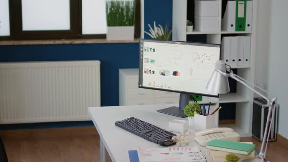 Nobody at Startup Office Desk with Sales Statistics on Computer alt