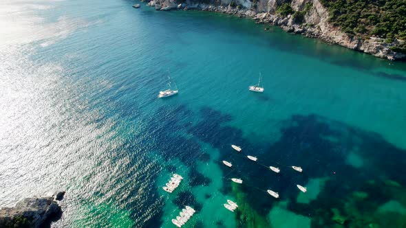 Aerial Drone View to Clear Blue Sea Water with Moored Boats and Yachts alt