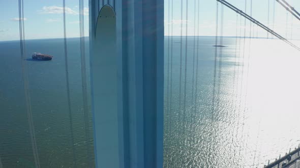 Aerial Drone Shot Descending Down the Side of a Verrazano Bridge Tower in NY alt