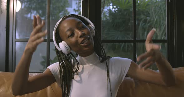 African American woman wearing headphones enjoying listening to music