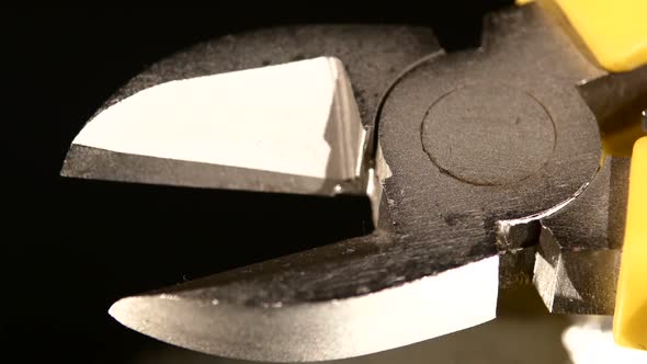 Silver Part of Wire Cutters with Yellow, Gray Handle on Black, Reflection, Macro, Rotation alt