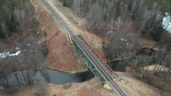 AERIAL: Bridge with Train Rail Road Constructed Over Remote Shallow River