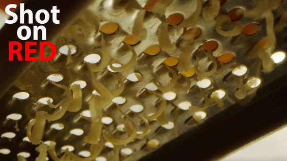 Grating Cheese A Low Angle Macro Shot Of Chef Hand On A Cheddar Grater alt