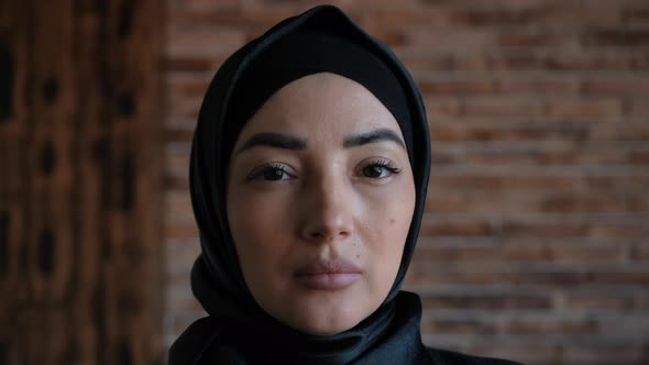 Close Up Portrait of Young Middle Eastern Muslim Woman in Hijab Looking Serious at Camera