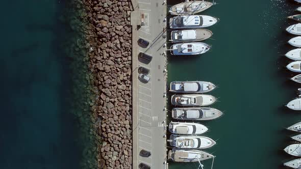 Bird's Eye View of a Small Marina with Ships and Boats alt