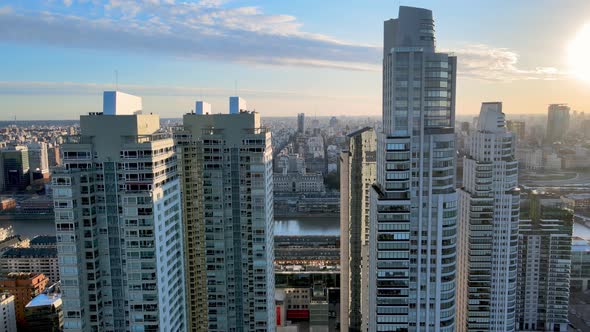Modern high-rise apartment buildings on the Rio de la Plata riverbank. Aerial cityscape during sunse alt