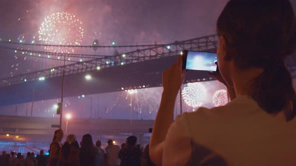 Attractive girl taking pictures on the phone alt