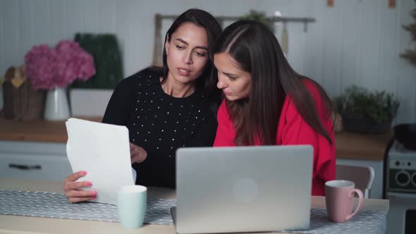 Women Freelancers Work at Home, Discuss Project, Use Documents and Laptop alt