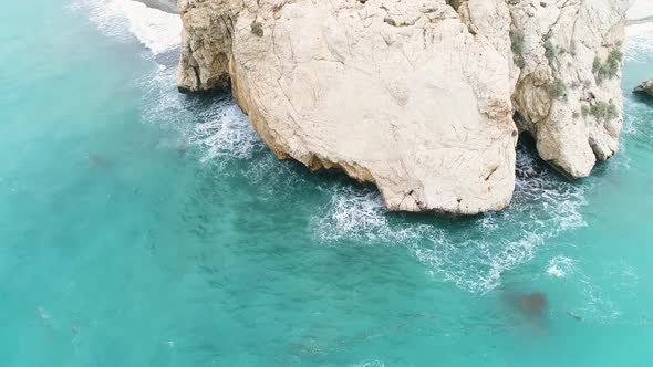 Aerial Top View of Cliff Rocks in a Blue Ocean alt